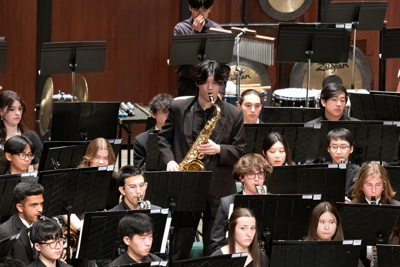 Ethan standing to play a tenor saxophone solo in the 2025 GMEA All-State Band