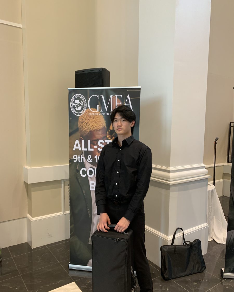 Ethan beside the GMEA All-State banner