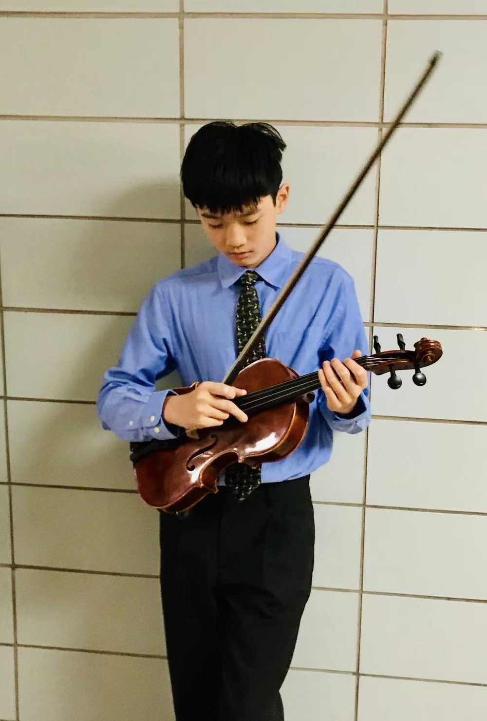 Young Ethan holding his viola